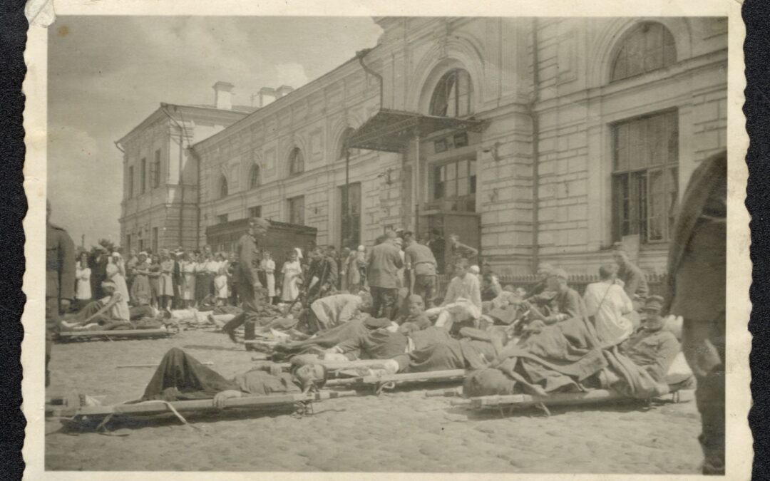 People lying on stretchers in front of the building