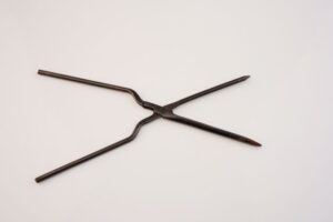 The photo shows a metal object in the shape of scissors