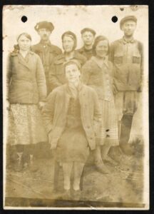 There is a group of men and woman in worker's uniforms on the photo