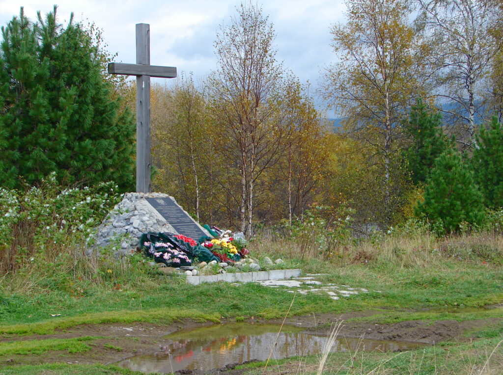 A cross surrounded by trees