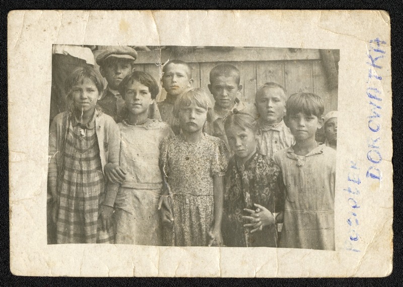 Grupa dzieci stojących na tle budynku