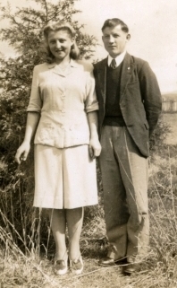 Young couple posing by the tree