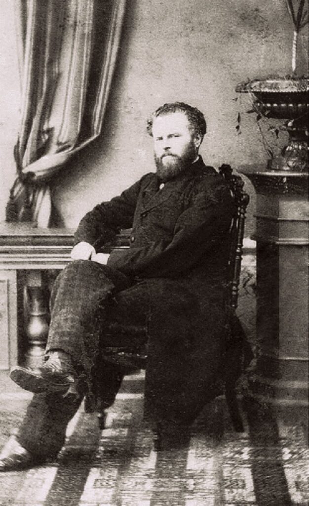 A photograph of a man sitting on a chair