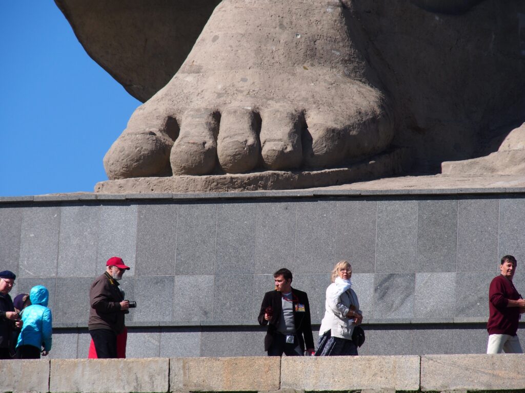 A photo of the part of a monument depicting a foot made of stone or concrete