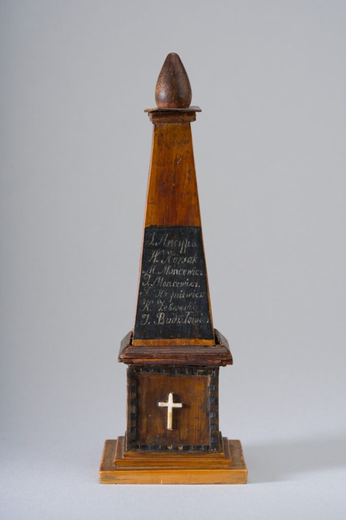 A small, wooden hand made obelisk
