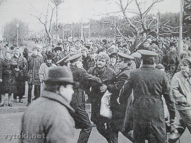 Policemen arresting a demontrating man during demonstration on the street.